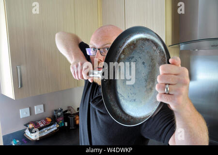man with cast iron pan Stock Photo