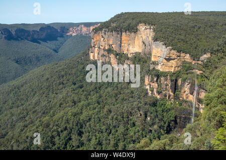 Slender waterfall tumbles over vertical cliffs at Govetts Leap in Australia's Blue Mountains near Sydney in New South Wales Stock Photo