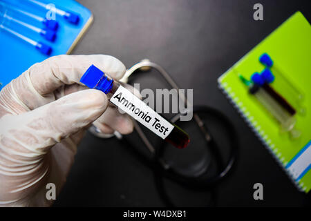 Ammonia Test text with blood sample. Top view isolated on black background. Healthcare/Medical concept Stock Photo