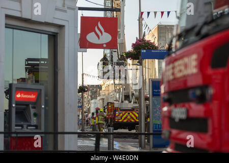 Southend on Sea, UK. 22nd July 2019. A fire has broken out above H&M store in the High Street. At least six fire appliances are on the scene with fire crews working to extinguish the fire. Penelope Barritt/Alamy Live News Stock Photo