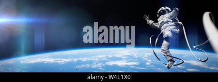 astronaut performing a spacewalk in orbit of planet Earth (3d illustration banner, elements of this image are furnished by NASA) Stock Photo