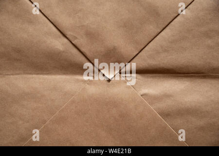 Light brown paper background in the form of craft envelope. Stock Photo