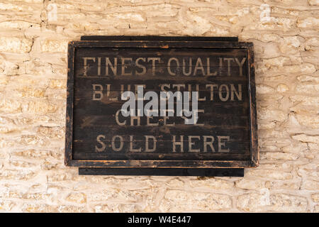 The Bell Inn Hotel, Stilton, Peterborough, England, UK - finest quality blue stilton cheese sold here sign Stock Photo