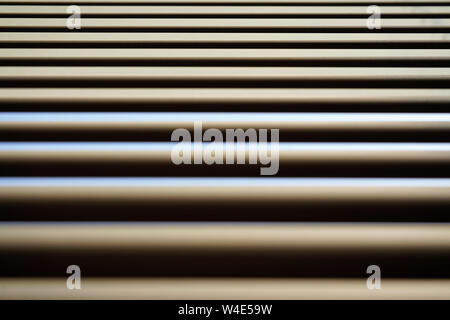 Detail on lines of metallic window blinds, some light reflects on, dust visible, abstract geometric background Stock Photo