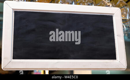 Blank sign, blur bar pub background. Blackboard with wooden frame, mockup template, copy space. Close up view Stock Photo