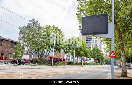Blank billboard mockup for advertising, City street empty background, Rotterdam, Netherlands, cloudy spring day