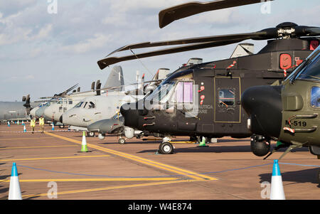 Various helicopters and aircraft on display in the evening sun at RIAT 2019, Fairford, Gloucestershire,uk Stock Photo