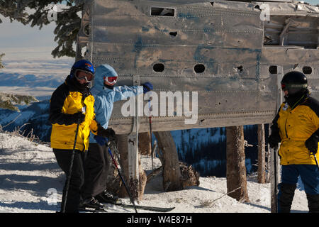 Skiers rub the wing fragment of the B-24 that crashed on Mission Ridge for good luck and to ensure it snows a lot. Many perform this ritual every run. Stock Photo