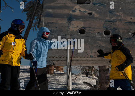 Skiers rub the wing fragment of the B-24 that crashed on Mission Ridge for good luck and to ensure it snows a lot. Many perform this ritual every run. Stock Photo