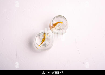 Two golden fish. Aquarium fish swim in glasses for wine. Pets. The concept of relationships, divorce, distance. Buying and selling fish Stock Photo