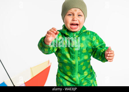 Little baby boy crying in the studio near umbrella Stock Photo