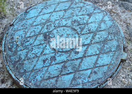 Old blue manhole. A diamond pattern on the old metal Stock Photo
