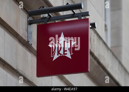 A sign for Pret A Manager hangs from one of the sandwich shop chain's stores in Manchester, UK. Stock Photo