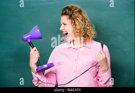 Teacher hold table lamp in hand chalkboard background. Knowledge day. Light up process of studying. Insight and idea. Educational idea. Woman work on bright shiny idea. Creativity and inspiration. Stock Photo