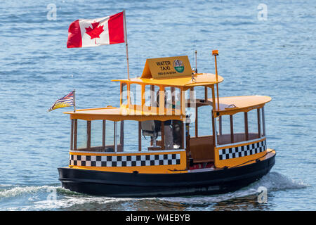 Water Taxi going across the harbour in downtown Victoria, BC. Stock Photo