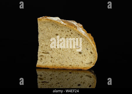 One slice of fresh baked rye wheat bread isolated on black glass Stock Photo