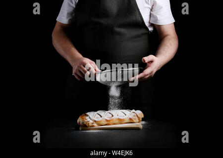baker decorating on dark background. recipe concept. Stock Photo