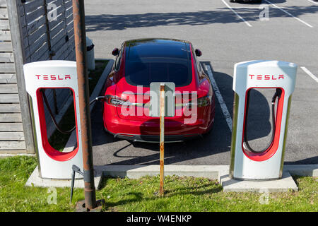 Tesla Model S parked, supercharging at Tesla's Cornwall, Ontario station. Stock Photo