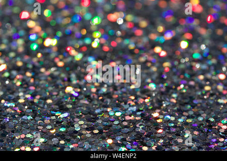 Macro abstract texture background of sparkling silver glitter reflecting colorful bokehdsx Stock Photo