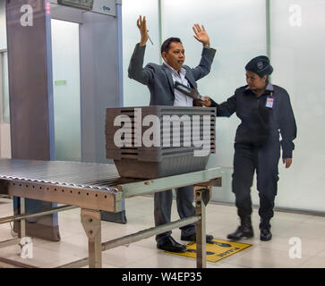 BANGKOK, THAILAND, NOV 27 2018, Control passengers and his baggage at the airport. Security officer at the airport checked people before departure. Stock Photo