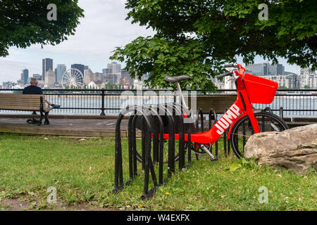 Montreal, Canada - 21 July 2019: Uber Jump electric bike locked to a bike rack in Jean Drapeau Park. Stock Photo