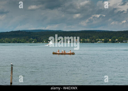 Reichenau-Oberzell, BW / Germany - 21 July 2019: horizontal teenage female friends rowing on Lake Constance on a beautiful summer day Stock Photo