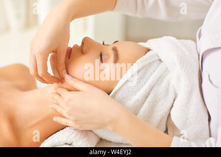 Facial massage to a beautiful girl in a beauty clinic. Stock Photo