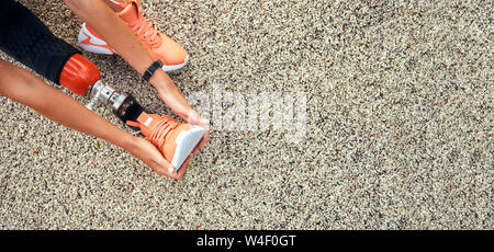 Top view of woman stretching her prosthetic leg. Web banner. Disabled sport concept. Advertising Stock Photo