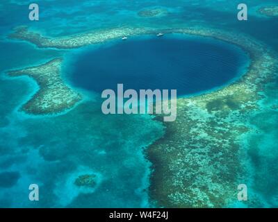 The Great Blue Hole from the air. Lighthouse Reef and Caye / Cay off Belize coast. Underwater Cenote Cave that collapsed. Limestone cave. Stock Photo