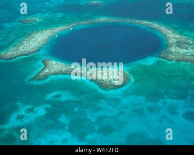 The Great Blue Hole from the air. Lighthouse Reef and Caye / Cay off Belize coast. Underwater Cenote Cave that collapsed. Limestone cave. Stock Photo