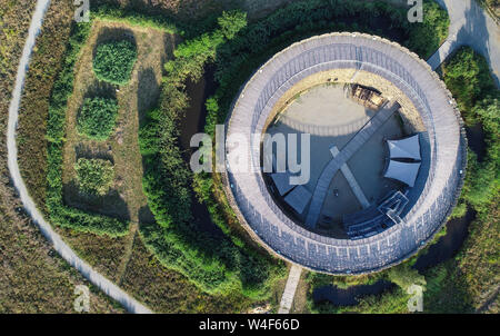 23 July 2019, Brandenburg, Raddusch: View of the Slavic castle in the Spreewald (aerial view with a drone). In the early Middle Ages, in the 9th/10th century, Lower Lusatia on the western edge of the Spreewald was covered by a dense network of small ring-shaped castle complexes. One of these Slavic castles stands today rebuilt at Raddusch. The Raddusch Slavic castle is a typical lousitz monument and reminds us of a culture that has largely disappeared today. Since 2003, the association Slawenburg Raddusch e.V. has been operating the entire facility on behalf of the executing agency, the city o Stock Photo