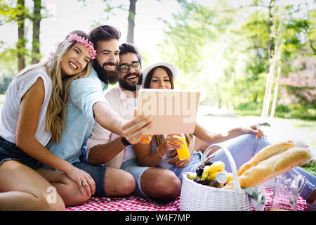 Group of young people taking a selfie outdoors, having fun Stock Photo