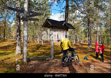 biking in the park, hikers, taiga forest, Ruska time (autumn), Pallas-Yllastunturi National Park, Lapland, Finland Stock Photo