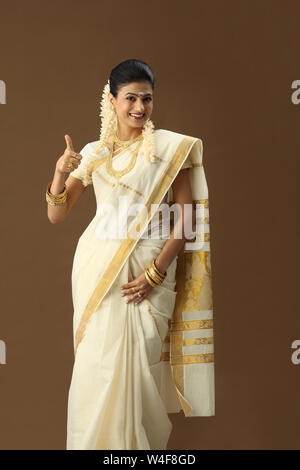 South Indian woman showing thumbs up sign and smiling Stock Photo - Alamy