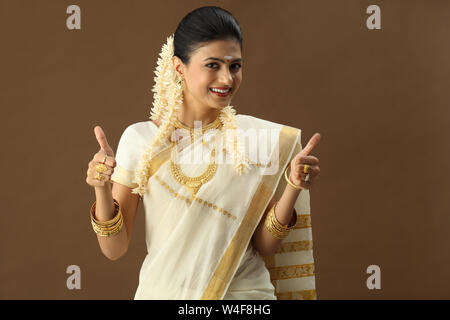 South Indian woman showing thumbs up sign and smiling Stock Photo - Alamy