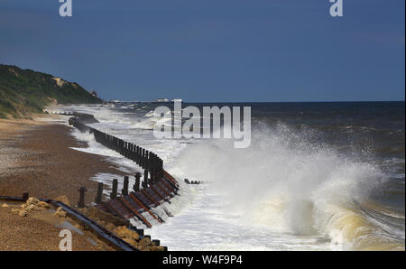 waves crashing on the beach at overstrand on the norfolk coast Stock Photo