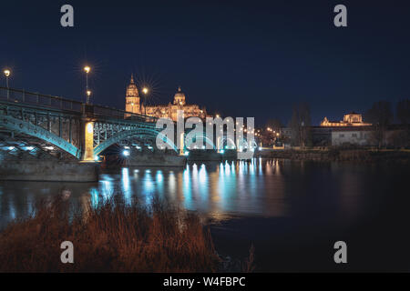 Salamanca Skyline view with Cathedral and Enrique Estevan Bridge from Tormes River at night - Salamanca, Castile and Leon, Spain Stock Photo