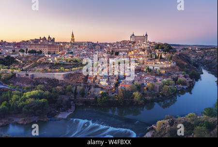 Beautiful view of Toledo city skyline with Cathedral, Alcazar and Tagus River at sunset - Toledo, Castila La Macha, Spain Stock Photo