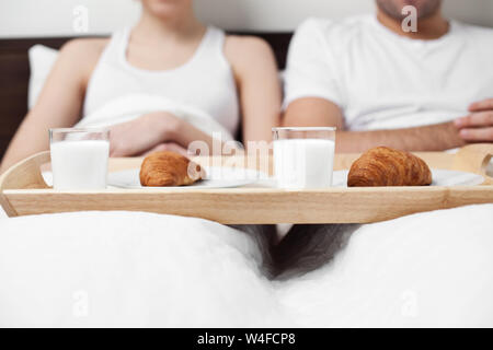 Couple eating breakfast in bed Stock Photo