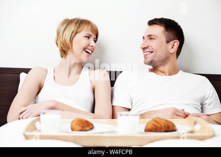 Couple eating breakfast in bed Stock Photo