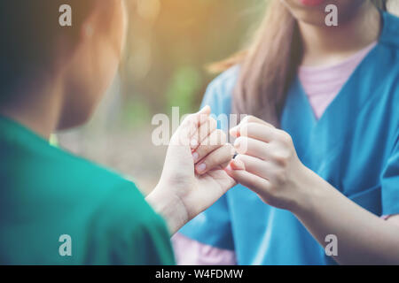 https://l450v.alamy.com/450v/w4fdmw/hands-hook-each-others-little-finger-on-nature-background-concept-of-promise-w4fdmw.jpg