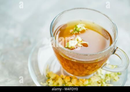 Jasmine tea in transparent cup with jasmine flowers, healthy herbal natural tea Stock Photo