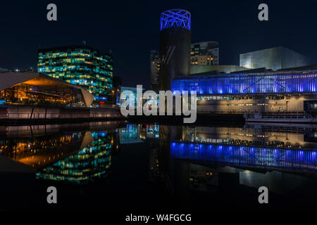The Alchemist restaurant, Digital World Centre building and the Lowry Arts Centre at night, over North Bay, Salford Quays, Manchester, UK. Stock Photo