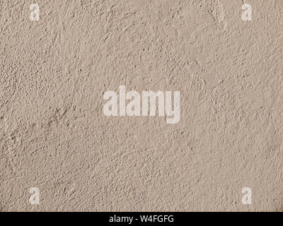 Textured grinded plaster in dark beige. Background or texture seamless pattern. Stock Photo