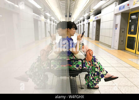 Tokyo, Japan. 23rd July, 2019. A lady awaits a Nanboku train at Shirokaneda train station in Tokyo, Japan on Tuesday, July 23, 2019. Photo by: Ramiro Agustin Vargas Tabares Credit: Ramiro Agustin Vargas Tabares/ZUMA Wire/Alamy Live News Stock Photo