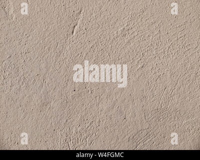 Textured grinded plaster in dark beige. Background or texture seamless pattern. Stock Photo