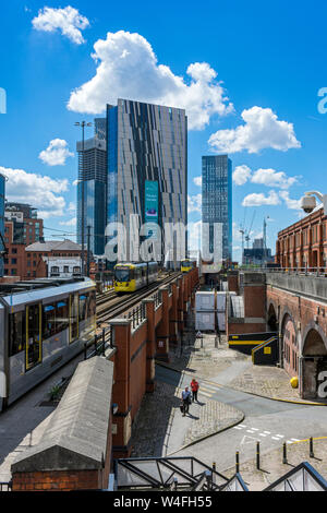 The Axis Tower and Deansgate Square apartment blocks (under construction) with a Metrolink tram in foreground,  Manchester, UK Stock Photo