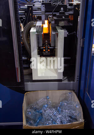 Water bottles from plastic bottle on blowing machine Stock Photo