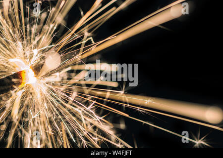 Sparkling sparkler in front of black background Stock Photo