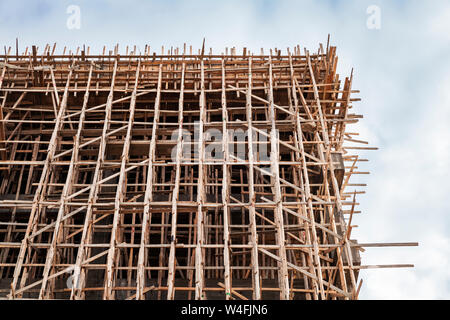 New building is under construction, wooden scaffolding structures, industrial background Stock Photo